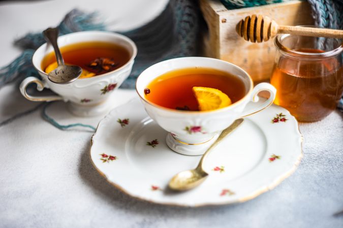 Tea and saucer with honey and lemon slice
