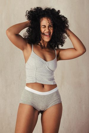 Happy female model celebrating her natural body wearing underwear