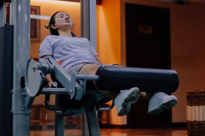 woman using leg extension machine