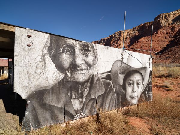 Outdoor mural photograph of older Navajo woman and boy by Chip Thomas