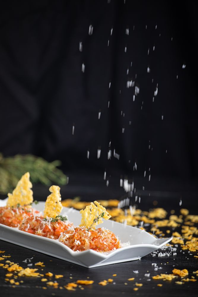 Tasty Quenelles of tomato fondue and Parmensan tile in ornamental plate