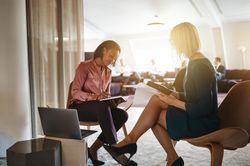 Two business women working together and taking notes