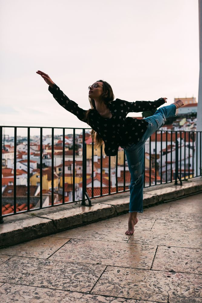 female dancer dancing against cityscape