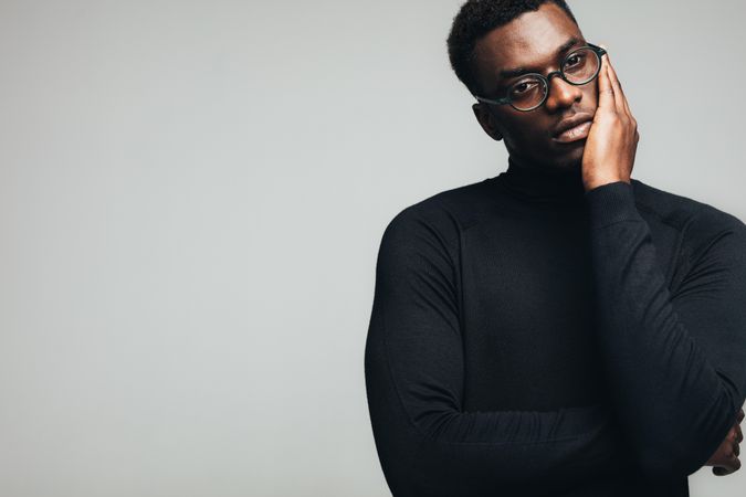 Thoughtful Black male in glasses and turtle neck