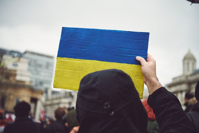 London, England, United Kingdom - March 5 2022:  Person with cardboard Ukrainian flag