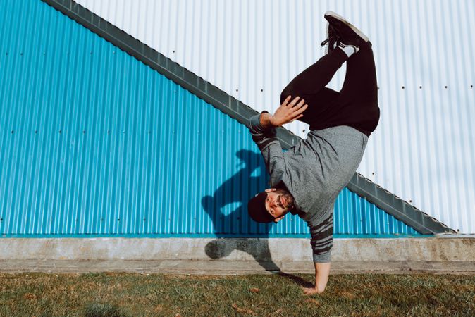 Man performing handstand near wall