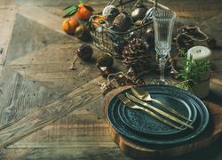 Top view of table setting with crystal flute of Champagne, pinecone, and candle, with copy space