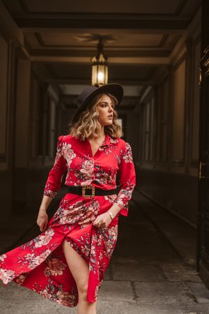 Elegant woman standing in old passage