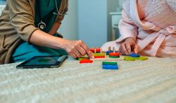 Female doctor showing geometric shapes to patient