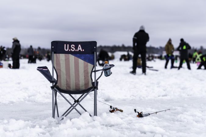 Nisswa, MN, USA - January 25th, 2020: A vacant “USA” chair with fishing rods