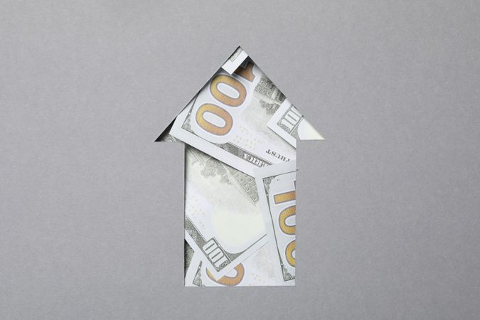 Up arrow with dollar bills, gray background