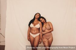 Two body positive young women wearing underwear in a studio 5ovyy0