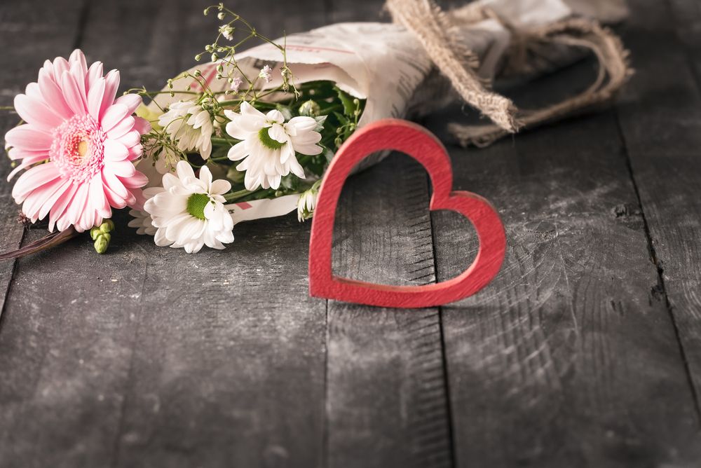 Flowers wrapped in newspaper and a heart