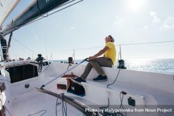 Sailor looking up while navigating on boat 0JQzdb
