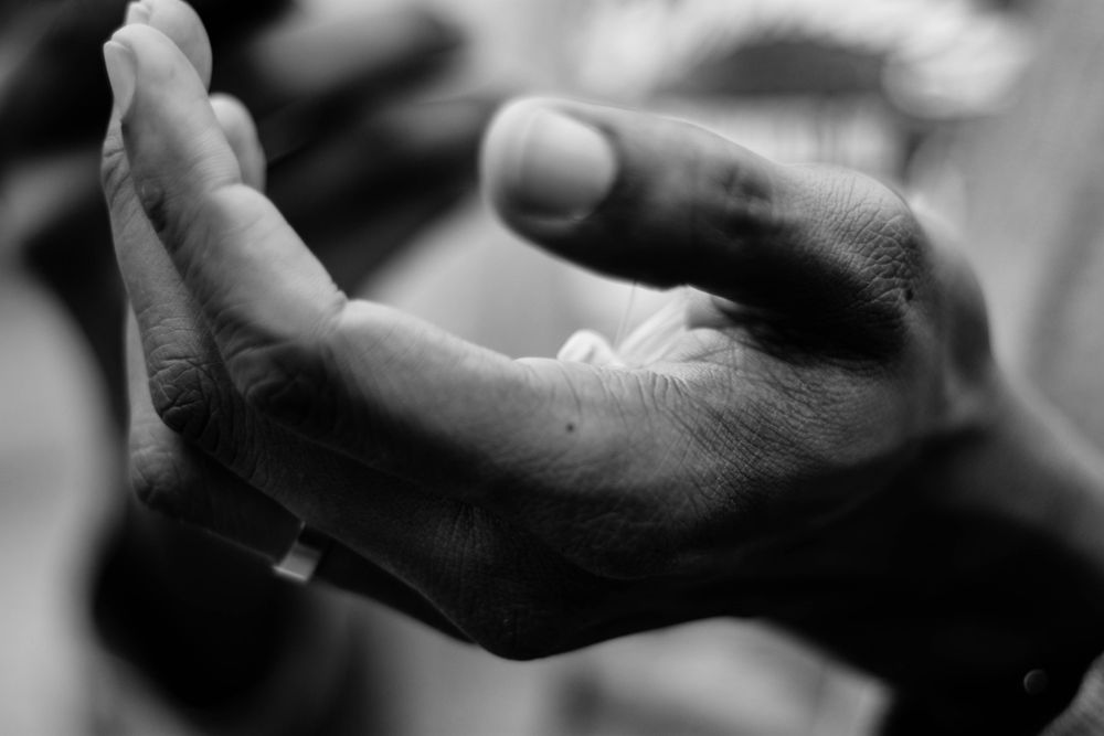 Grayscale photo of a hand up
