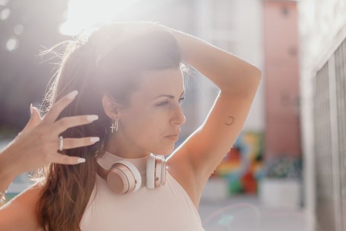 Brunette listening to music in sunlight