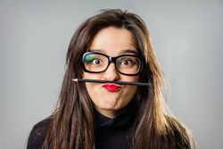 Woman holding a pencil with her red lips