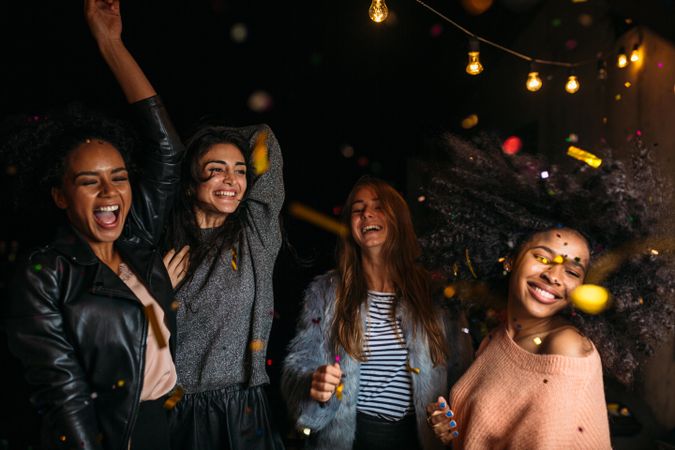 Multi-ethnic group of female friends dancing outdoors