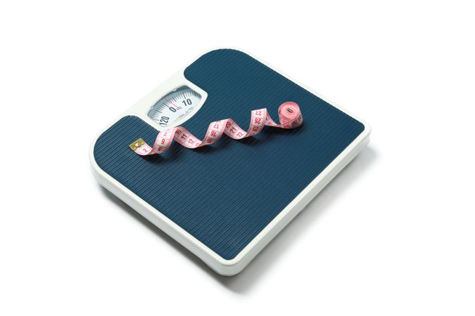 Weigh scales and measuring tape isolated on blank background