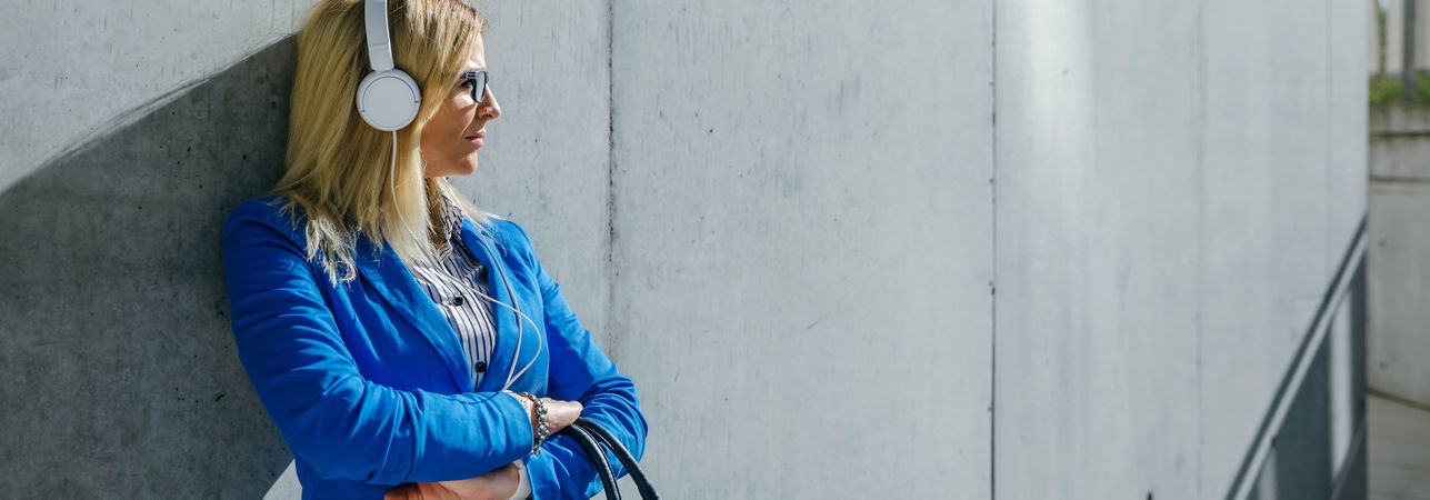 Businesswoman with headphones posing