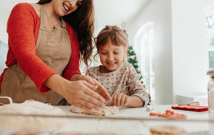 Mother teaching baking to daughter for Christmas