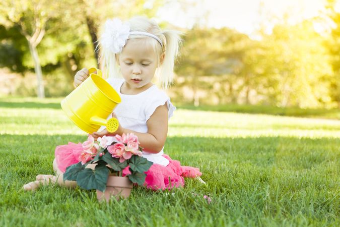 Cute Little Girl Playing Gardener with Her Tools and Flower Pot.