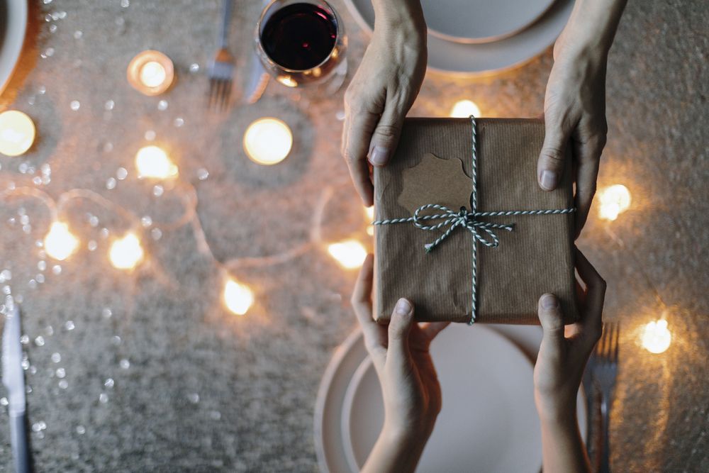 Birdseye view of hands passing a gift