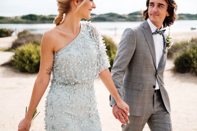 Happy young married couple spending time together at seaside