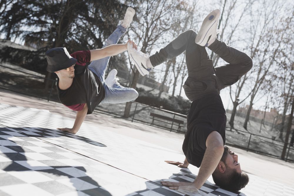 Young men dancing break dance in park
