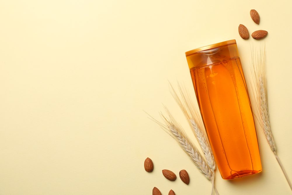 Composition with shampoo bottle on beige background, space for text