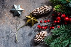 Xmas holiday card concept with top view of pine cones and star ornaments