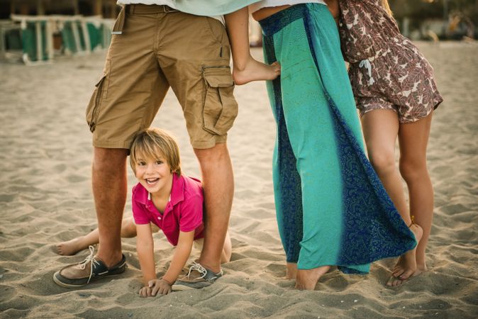Crop parents with kids on beach