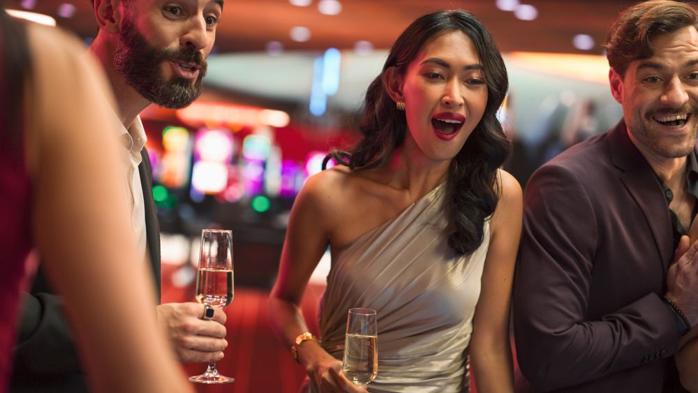 Cheerful Asian Woman is Excited, Talking with Boyfriend and Clinking Champagne Glasses