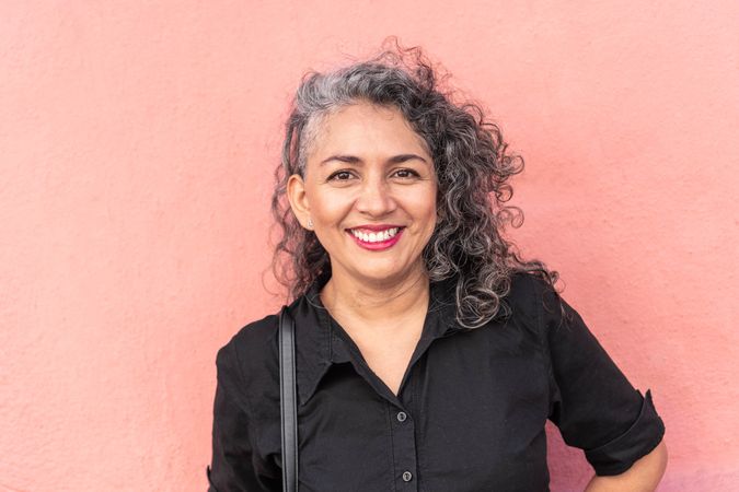 Latina woman with gray hair standing in the street