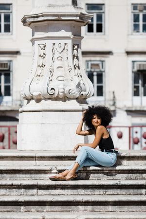 Black female siting on stairs outdoors