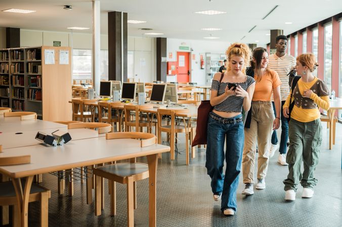 Diverse students leaving library together