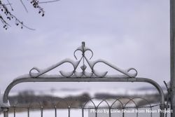 Snow resting on an ornamental gate 0VNZX0
