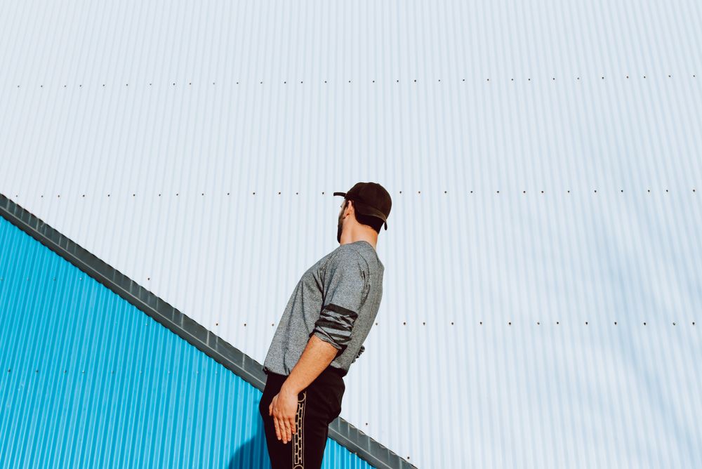 Trendy male flipping on street