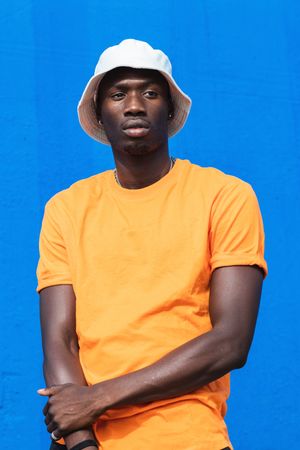Black man in bright sporty outfit and cap