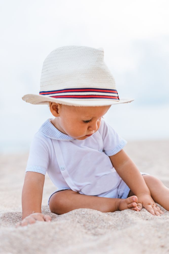 Baby on the beach with hat