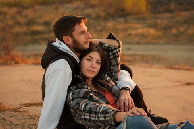 Couple sitting dusk countryside