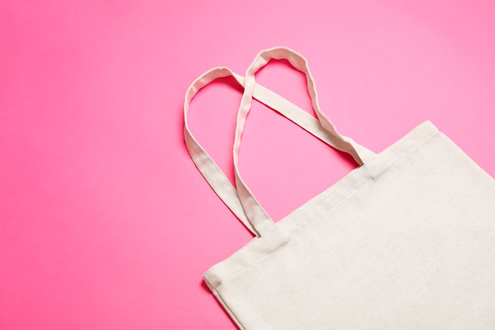 Eco bag on color background, space for text
