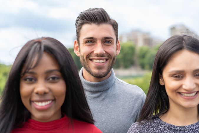 Joyful multicultural friends in city park