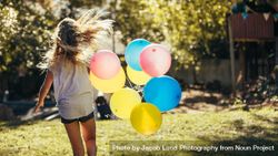 Girl having fun outdoors with balloons 4ZVMO4