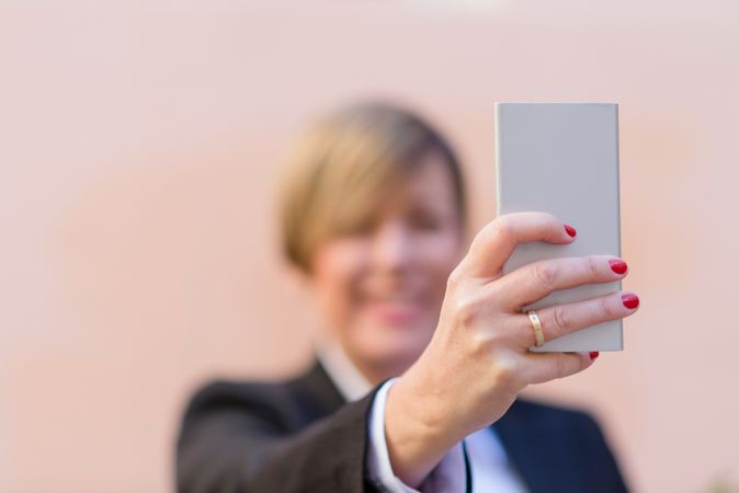 Woman holding phone with selective focus
