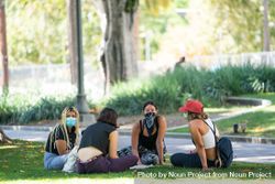 Los Angeles, CA, USA — June 16th, 2020: group of women sitting on grass at rally in discussion 5lVa7b