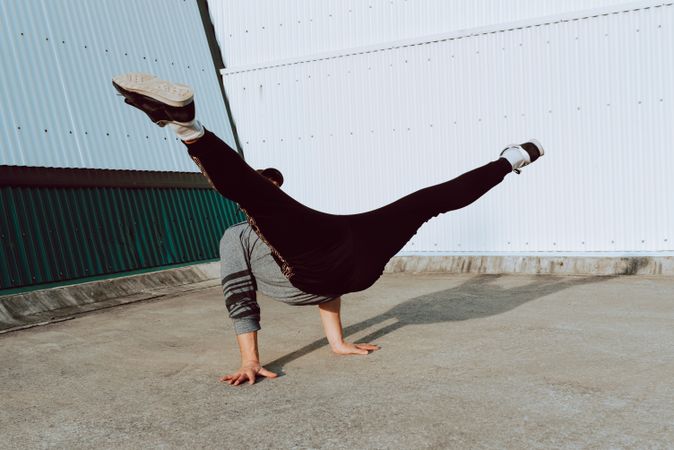 Man performing handstand near wall