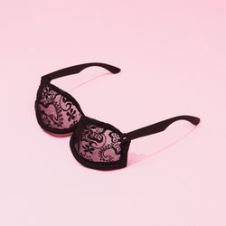 Half bra, half sunglasses on pink background