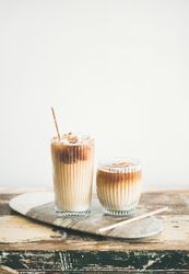 Two cups of iced coffee in clear classes with eco friendly straight on light background