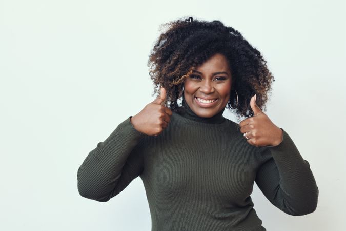 Smiling Black woman with her thumbs up
